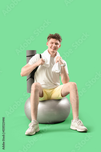 Sporty young man with towel...