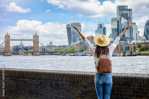 Photography A happy tourist woman on a sightseeing trip looks at the skyline of London, Engl