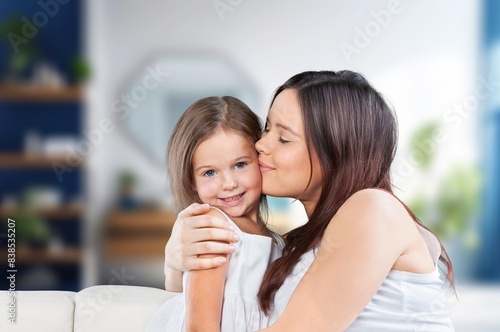 Mother holding cute baby at home