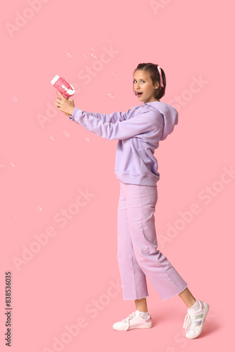 Teenage girl with soap bubb...