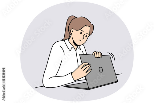 Woman is worried about privacy of data on internet and hides laptop screen while entering password. Taking care of security using internet and maintaining confidentiality to avoid information leakage