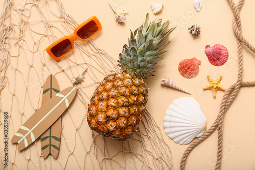 Photos Sunglasses, pineapple, surfboards and seashells on beige background