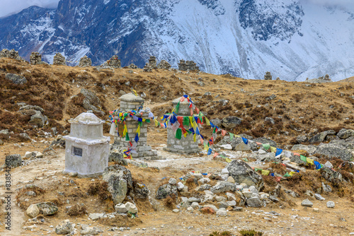 Colorful Nepali and Tibetan prayer flags fluttering in the majestic mountains of Nepal. Symbolizing peace, compassion, and blessings, flags adorn the serene landscape of Himalaya mountains photo