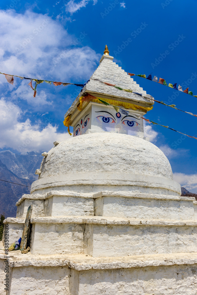 Stupa with Buddha eyes in Nepal. Religious building of buddhism pagoda in the high Himalaya mountains and Kathmandu capital city. Sacred place of Buddhism with prayer flags in beautiful peaceful place Stupa with Buddha eyes in Nepal. Religious building of buddhism pagoda in the high Himalaya mountains and Kathmandu capital city. Sacred place of Buddhism with prayer flags in beautiful peaceful place