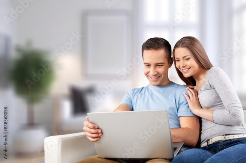 Happy young couple with digital gadget