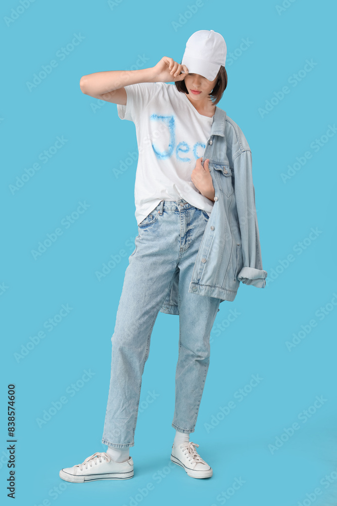 Beautiful young woman in stylish clothes on blue background Beautiful young woman in stylish clothes on blue background