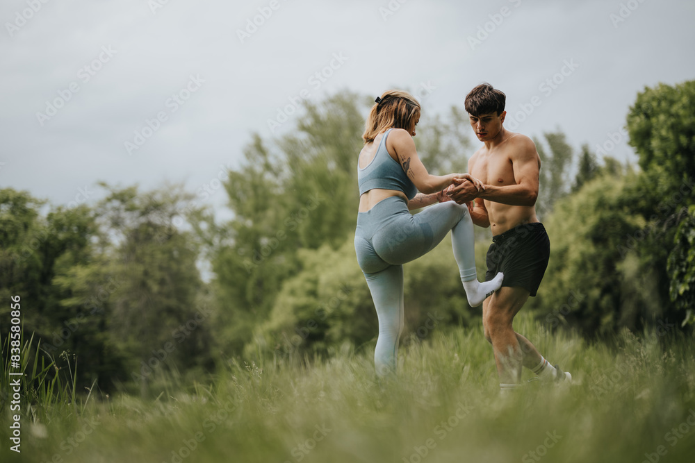 Two people exercising together outdoors in a park, focusing on fitness and teamwork. Two people exercising together outdoors in a park, focusing on fitness and teamwork.