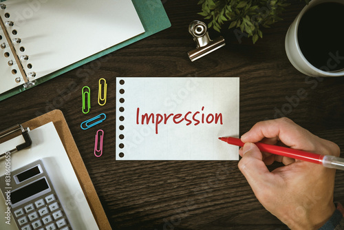 There is notebook with the word Impression. It is as an eye-catching image.