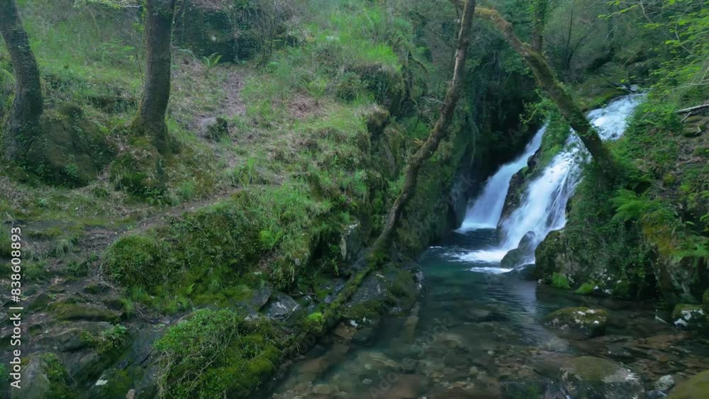 Hidden waterfalls cascading from moss-covered rock mountains in Santa Leocadia, Mazaricos, Spain. Hidden waterfalls cascading from moss-covered rock mountains in Santa Leocadia, Mazaricos, Spain.