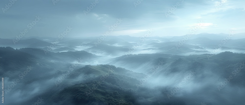 Fototapeta premium The fog envelops the scenery like a spectral veil, capturing the wide-angle view of the misty countryside at daybreak, serene and enigmatic, with its soothing colors and delicate illumination.