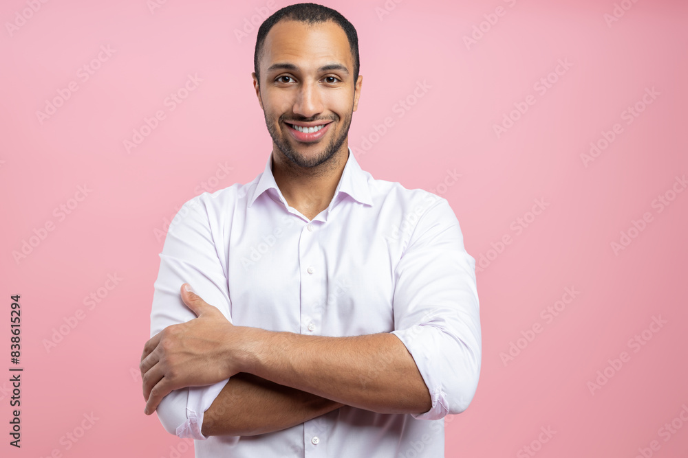 Confident man in white shirt standing with crossed arms Confident man in white shirt standing with crossed arms