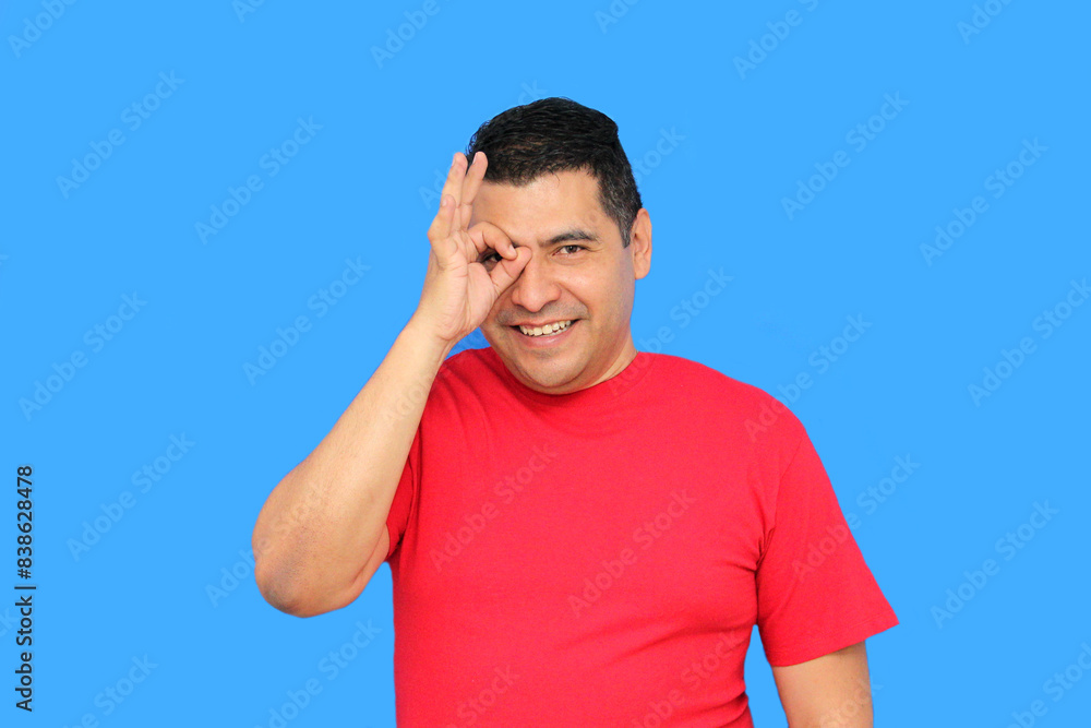 Dark-skinned latin adult man makes the ok sign with his fingers showing positive and happy Dark-skinned latin adult man makes the ok sign with his fingers showing positive and happy