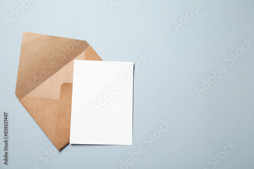 Letter envelope and card on grey background, top view. Space for text © New Africa