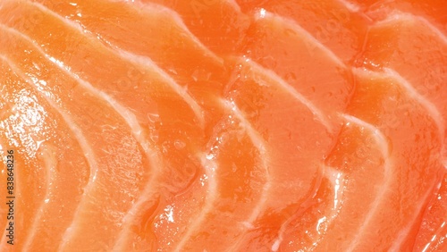 Dive into the salmon's world: Velvety strands of muscle interlace with pockets of rich adipose tissue, bathed in a vibrant orange hue of astaxanthin. Its lustrous surface mirrors the freshness within.