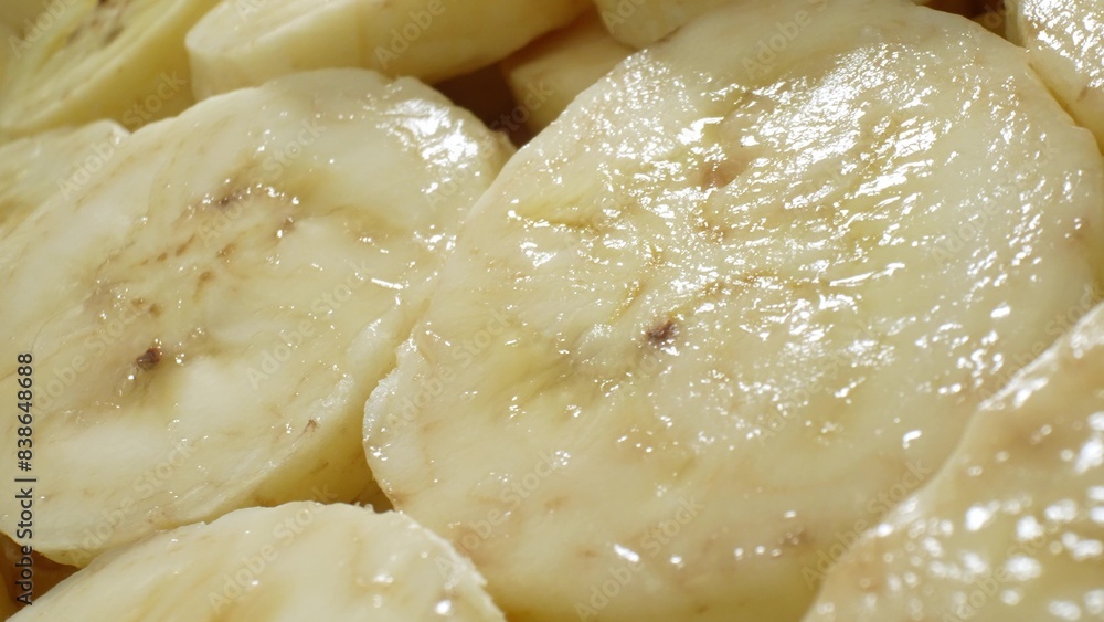In this intimate view, sliced bananas unveil their luscious interior, boasting a uniform texture with subtle brown flecks at the core. The soft, glossy appearance promises a delectable indulgence.
In this intimate view, sliced bananas unveil their luscious interior, boasting a uniform texture with subtle brown flecks at the core. The soft, glossy appearance promises a delectable indulgence.