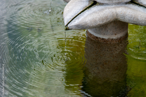 View of the flowing water on the fountain photo