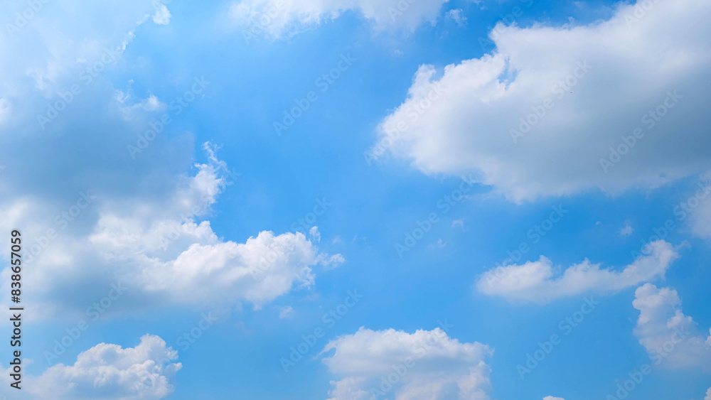 A serene blue sky filled with fluffy white clouds scattered across the expanse. The sunlight illuminates the scene, creating a peaceful and uplifting atmosphere. Nature's beauty background.
A serene blue sky filled with fluffy white clouds scattered across the expanse. The sunlight illuminates the scene, creating a peaceful and uplifting atmosphere. Nature's beauty background.