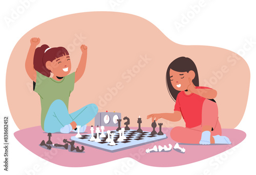 Two Young Girls Playing Chess. One Girl Joyfully Raises Her Arms In Victory, While The Other Appears Disappointed