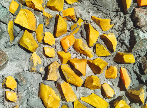 Abstract texture of yellow opaque glass. Fragment of a multi-colored matte mosaic from smalt of the USSR period.