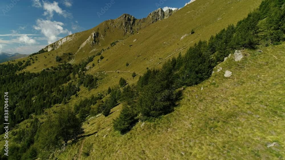 Aerial drone shot green picturesque mountainous landscape on a sunny day.