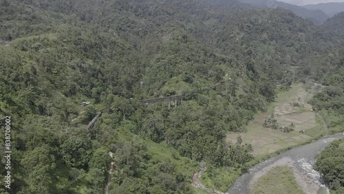 Establish aerial view of the Batu Busuk Hydroelectric Power Plant is one of the villages in Padang City surrounded by forests and rivers d-log raw stock video photo