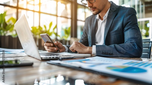 imagine something related with a sales professional, doing a lot of things at the same time, using a laptop, using a cellphone and making some notes on a notebook.