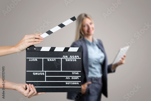 Actor performing on background of film clapperboard