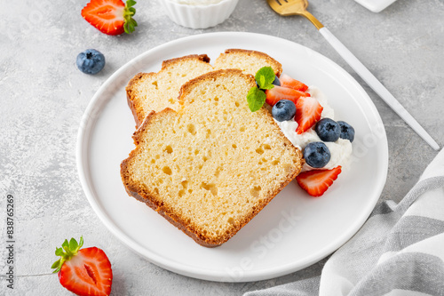 Canvas Print Delicious vanilla pound cake served with fresh berries and whipped cream on a gray concrete background