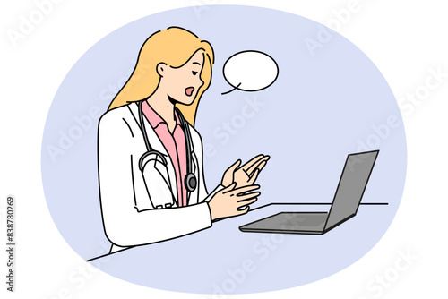 Doctor with laptop provides telemedicine services by consulting patients via internet. Woman telemedicine specialist in white remotely examines patient and gives recommendations for treatment