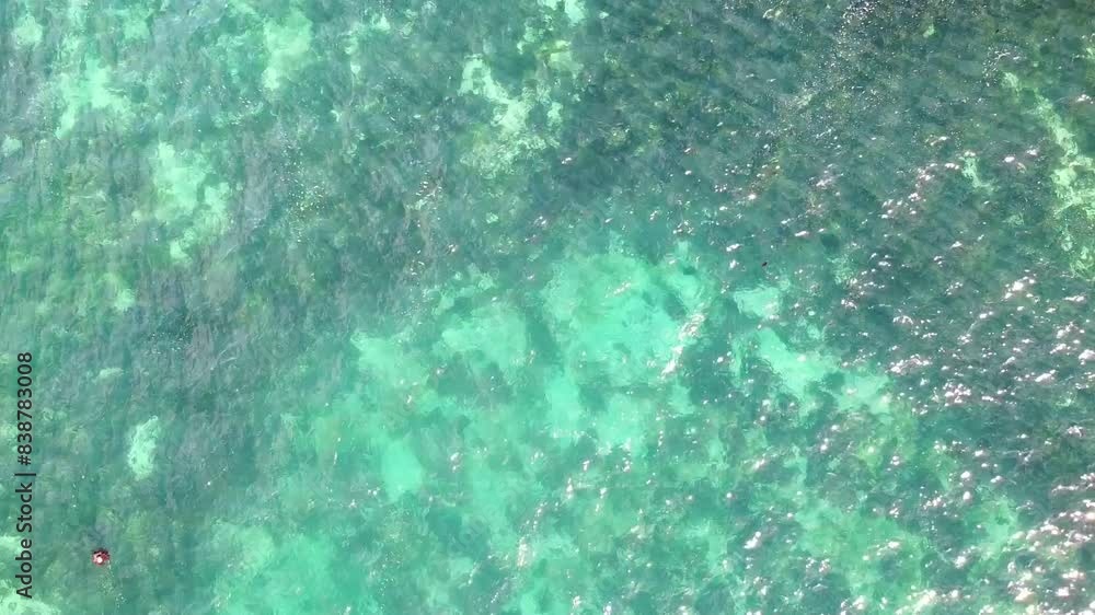 Aerial ascending view over clear waters near reef break Aerial ascending view over clear waters near reef break