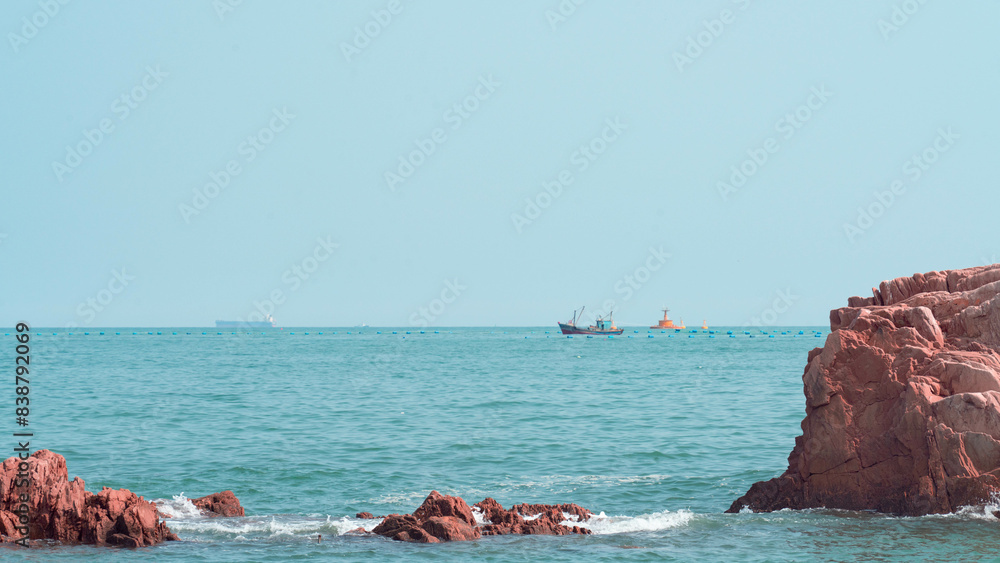 Fototapeta premium Red rocks in the sea