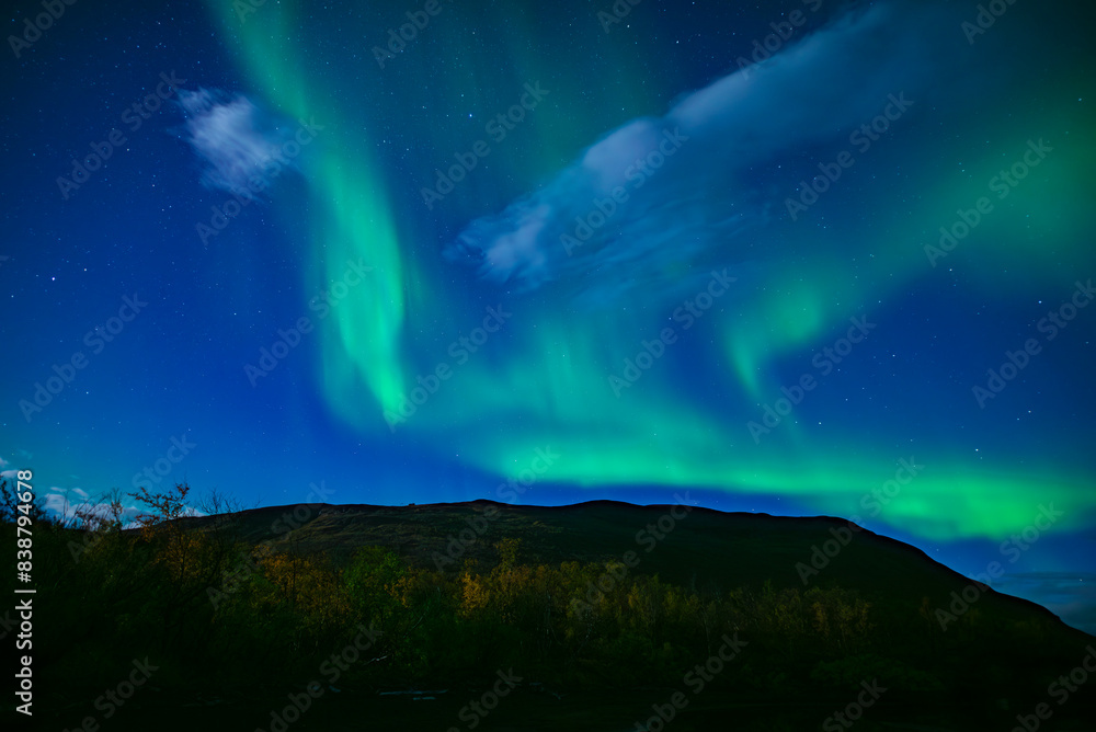 Northern lights dancing over calm lake in Abisko national park in north of Sweden. Northern lights dancing over calm lake in Abisko national park in north of Sweden.