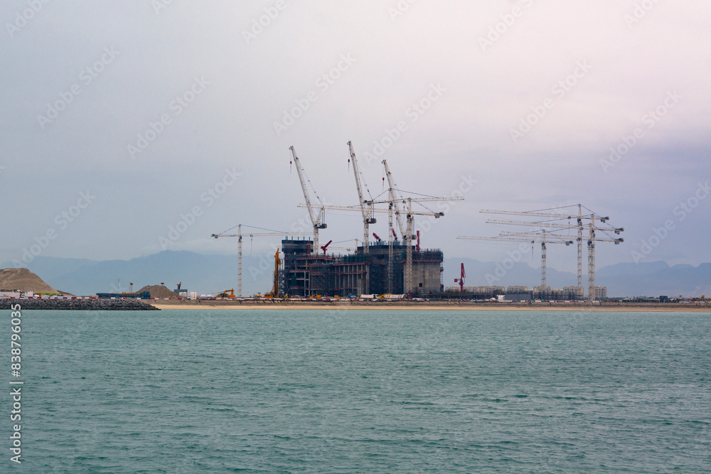 Construction progress of new modern hotels , United Arab Emirates. Cranes and building equipment Construction progress of new modern hotels , United Arab Emirates. Cranes and building equipment