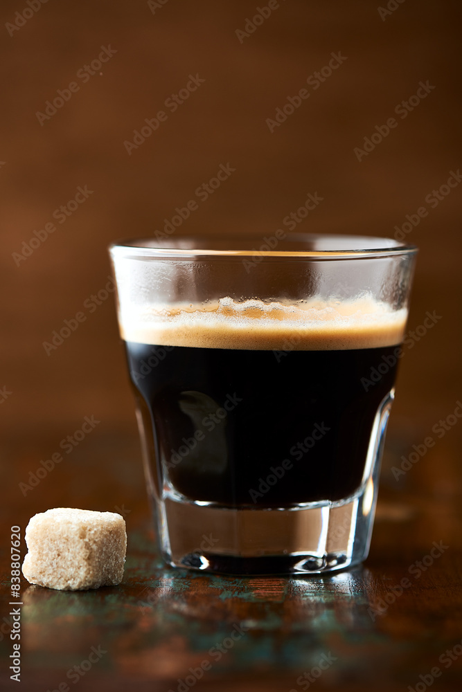 Coffee in glass cup on dark background. Close up. Copy space Coffee in glass cup on dark background. Close up. Copy space