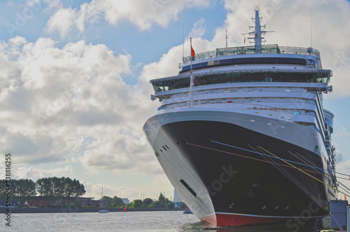 Luxury ocean liner cruiseship cruise ship Queen Victoria in 
 port in sunny blue sky Warnemunde harbor terminal infrastructure during Summer Baltic cruising photo