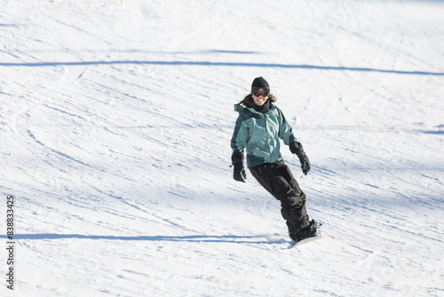 Woman snowboarding happily at June Mountain.