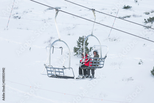 Boys riding the gondola up the mountain to ski.