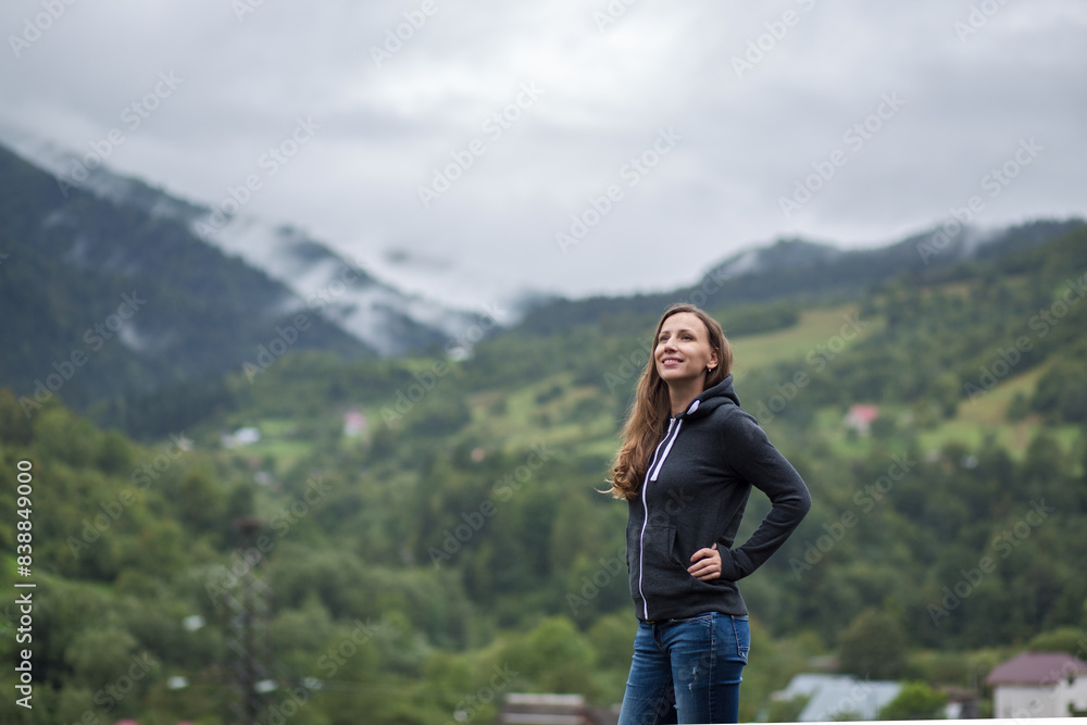 Young woman enjoying fresh air and beautiful view in mountains Young woman enjoying fresh air and beautiful view in mountains