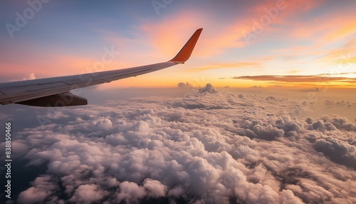 Grainy sky and a plane flying in to the clouds; aircraft with beautiful sunset glow, view from inside an aeroplane for background texture of cloudscape