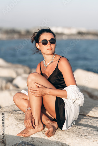 Woman sitting on rock by water © bedya