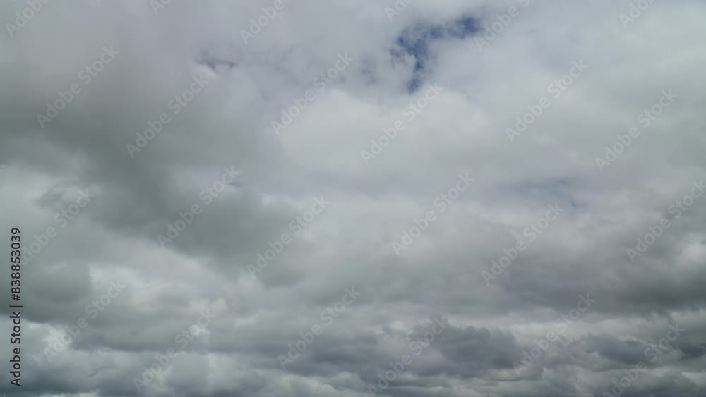 White and grey bottomed clouds rolling towards a darker cloudy horizon. Weather pattern example. Time lapse 30x. White and grey bottomed clouds rolling towards a darker cloudy horizon. Weather pattern example. Time lapse 30x.