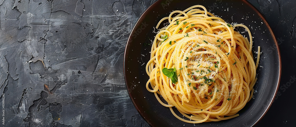 Dark plate with italian spaghetti on dark background with empty copy space Dark plate with italian spaghetti on dark background with empty copy space