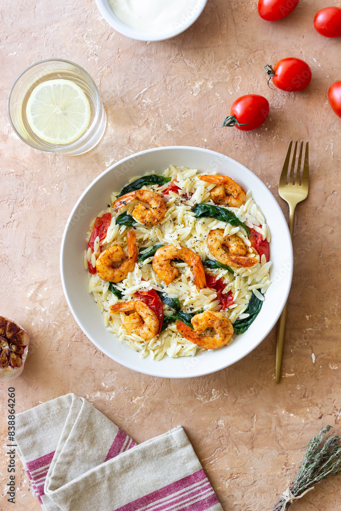 Orzo pasta with shrimp, spinach and tomatoes. Italian Cuisine. Seafood. Orzo pasta with shrimp, spinach and tomatoes. Italian Cuisine. Seafood.
