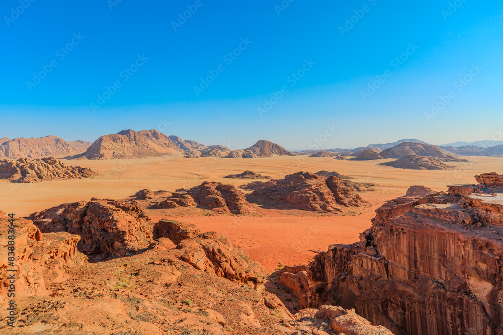 panoramic view of the vast expanse of Wadi Rum's desert landscape under a clear, expansive sky in Jordan in Al Ghuroub sunset point of Um Sabatah area panoramic view of the vast expanse of Wadi Rum's desert landscape under a clear, expansive sky in Jordan in Al Ghuroub sunset point of Um Sabatah area