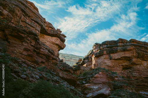 Dramatic clouds hang over sparse canyons in Arizona at sunrise.