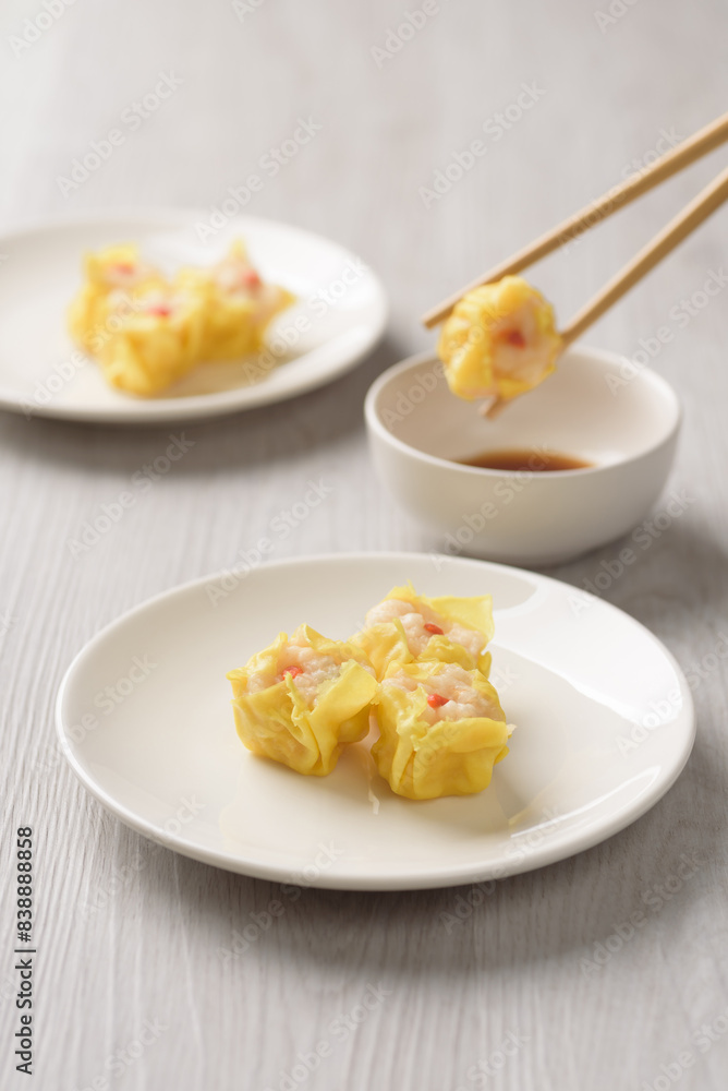 Shrimp shumai, wonton stuffed or dumplings, Asian cultural food on white table background Shrimp shumai, wonton stuffed or dumplings, Asian cultural food on white table background