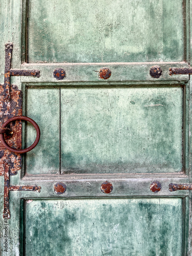 Old textured green door on Changdeokgung palace, famous landmark in Seoul. photo