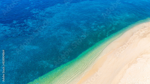 Top view of sandy beach for summer vacation concept. Nature of the beach and sea in summer with sunlight, and light sand. The sea sparkles against the blue sky. Sandy Beach for summer vacation concept © Photo Sesaon