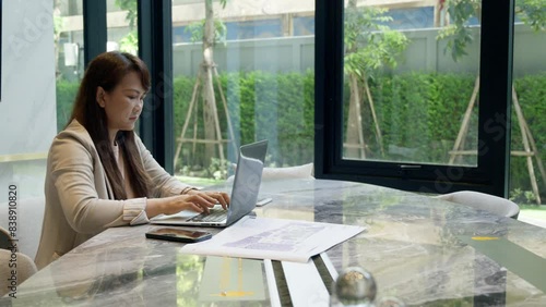 The businessman and businesswoman are using laptops and collaborating in a modern co-working space. the concept of teamwork, innovation,technology and modern work culture.