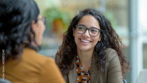Woman at office. Two businesswoman talking and sitting. Meeting people, colleague at workplace. Women teamwork. Female team